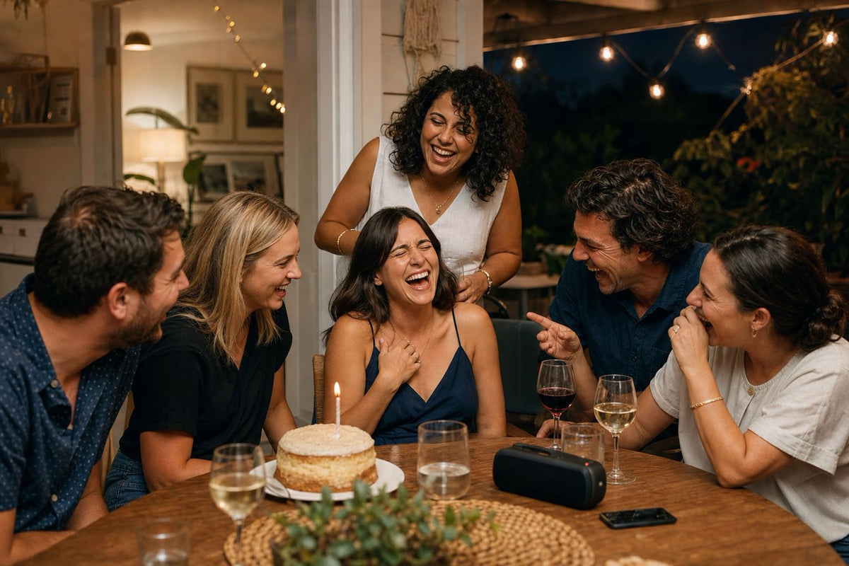 Friends laughing together while a personalised birthday song plays at a party
